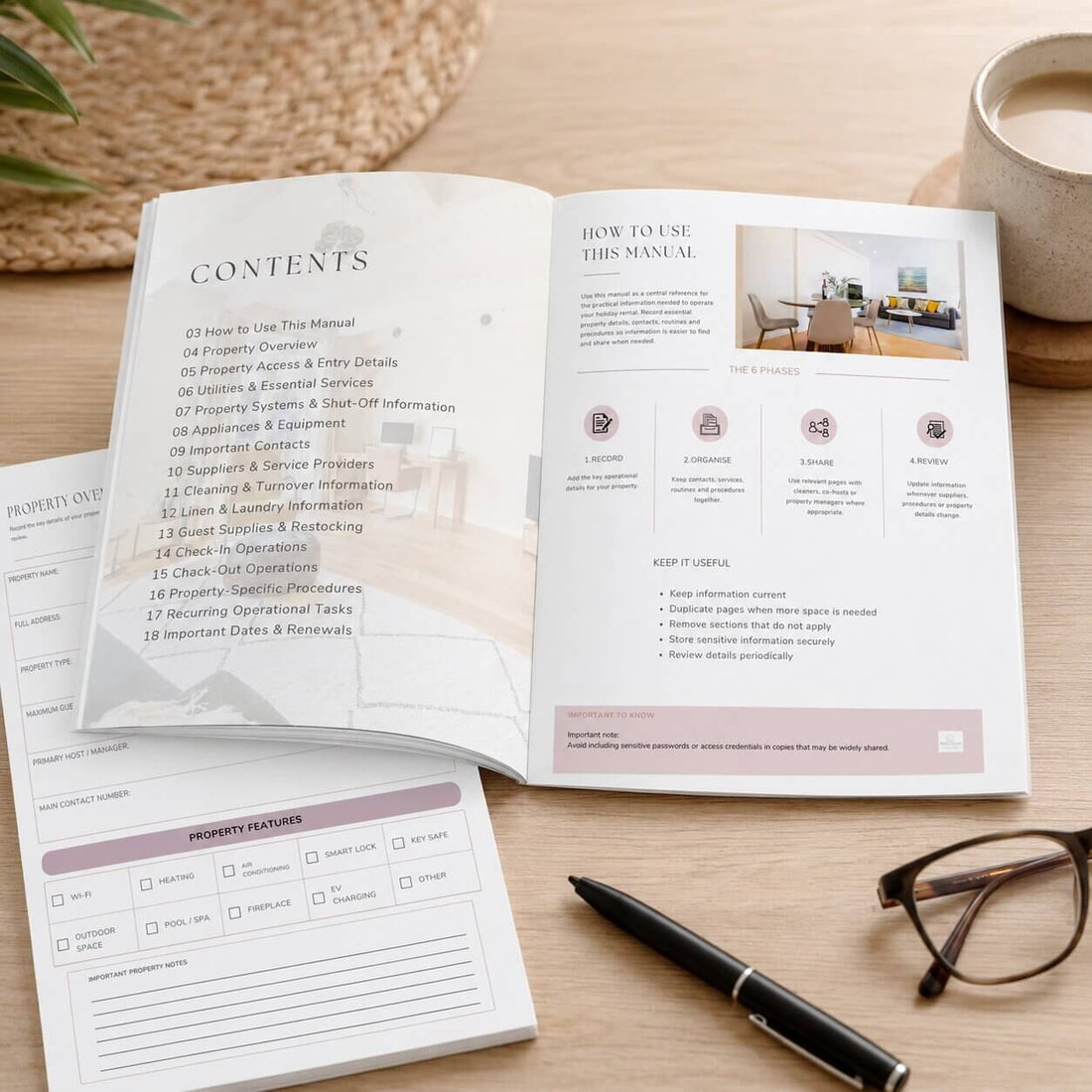A hardcover manual titled 'Holiday Rental Property Operations Manual' standing on a wooden table in a bright, modern room. The cover features a soft, faded photo of a living room interior.