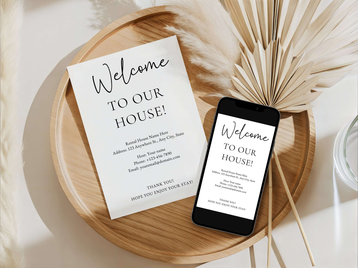 A styled flat-lay showing a printed welcome sign and a smartphone displaying the same welcome message, arranged on a round wooden tray with dried palm leaves and soft white decor.