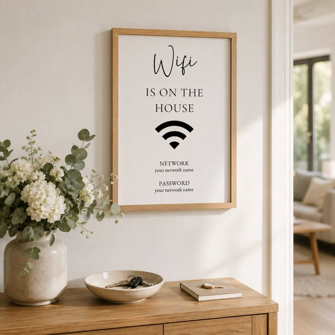Editable Airbnb Wi-Fi sign template displayed in a natural oak frame beside a Wi-Fi router in a modern Scandinavian-style holiday rental.
